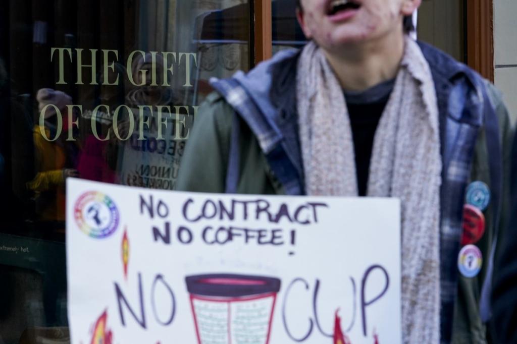 Starbucks workers engaging with customers about the importance of their strike