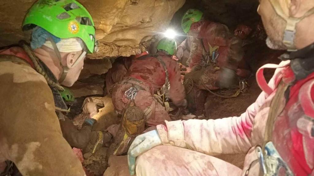 Rescuers working closely to secure the injured spelunker