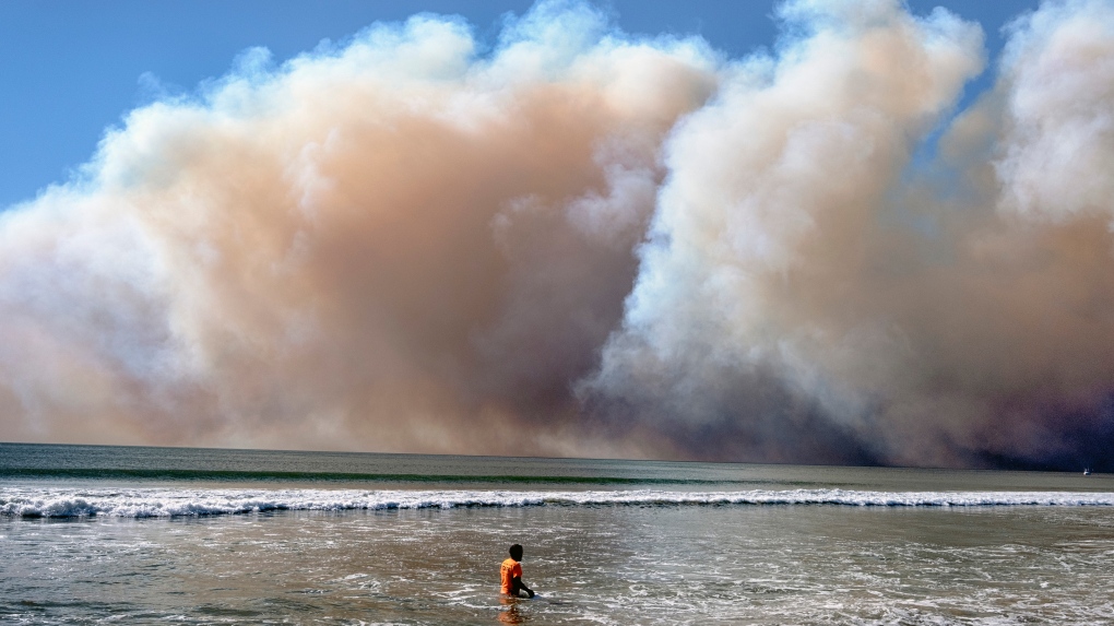 Firefighters battling the wildfire in a residential area