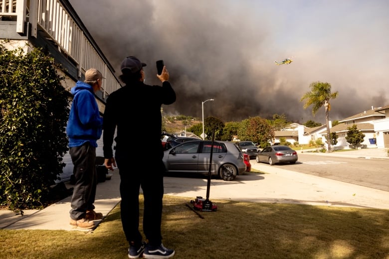 Aerial view of the fire spreading through residential neighborhoods