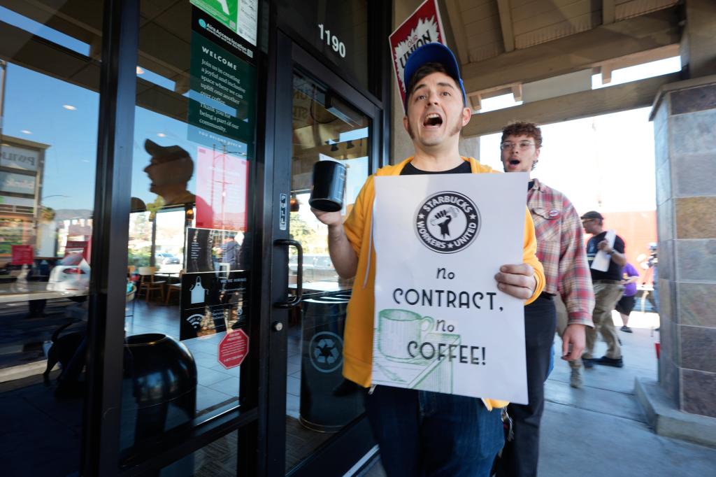 Union workers striking outside a Starbucks store