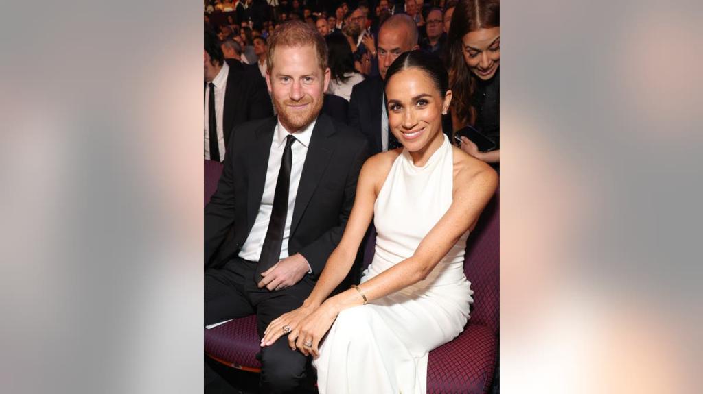 Meghan hugging a young girl during an engagement