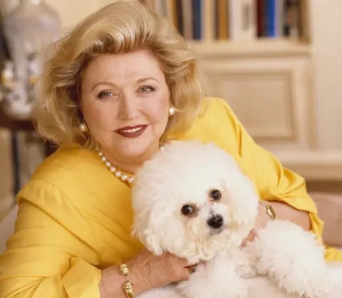 Barbara Taylor Bradford during a book signing event, engaging with her fans